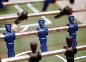 pexels-photo-11725506-11725506 Detailed view of blue plastic foosball players on a soccer table game surface, perfect for game enthusiasts.